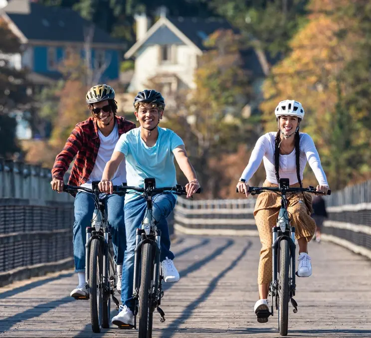 A group of friends enjoy a bike ride along the Selkirk Trestle in Victoria, BC