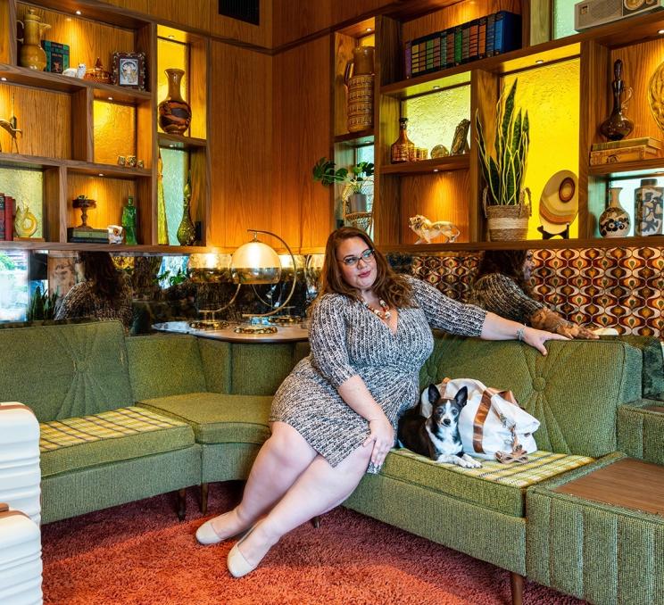 A woman and her dog wait in the lounge at Hotel Zed, a retro themed hotel in Victoria, BC
