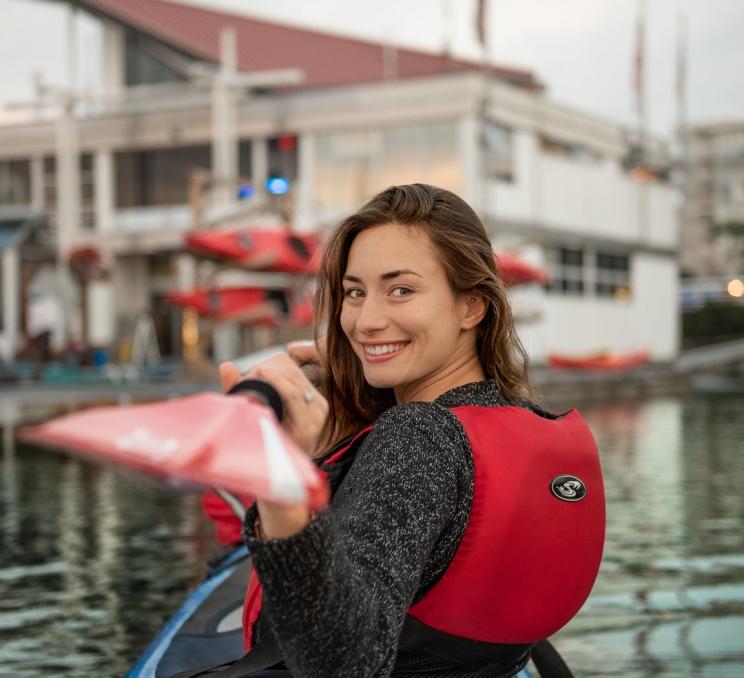 A woman kayak's in the Sidney Harbour in Victoria, BC