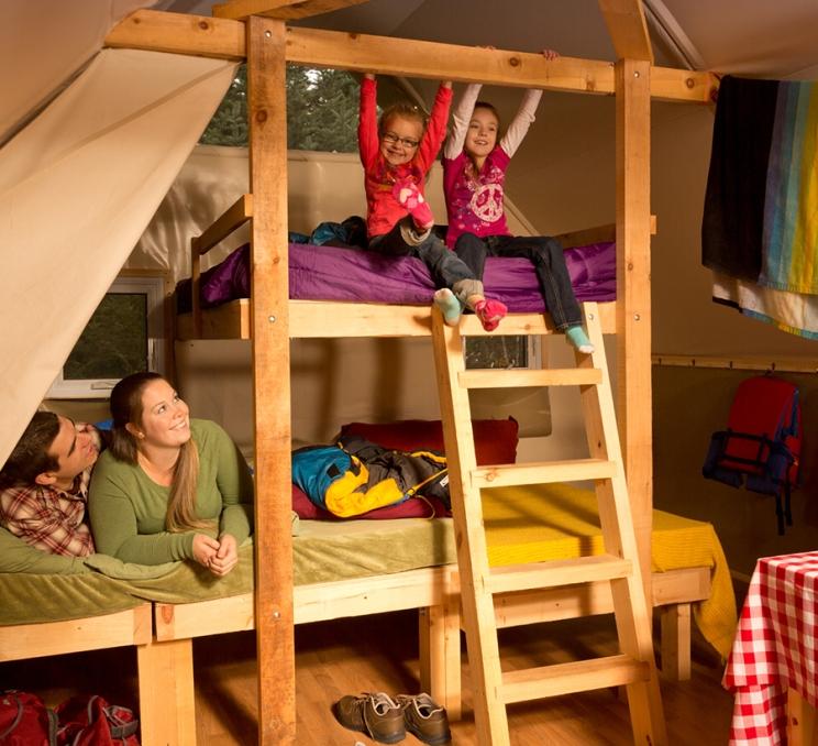 A family settles down for the night in an oTENTiks at Ford Rodd Hill & Fisgard Lighthouse National Historic Site of Canada in Victoria, BC
