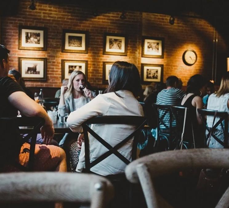 A group dines at Ferris' Upstairs Seafood & Oyster Bar on Yates Street in Victoria, BC