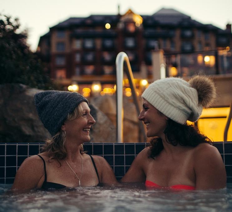 A couple of women soak in a hot tub at the mineral pools of Oak Bay Beach Hotel in Victoria, BC