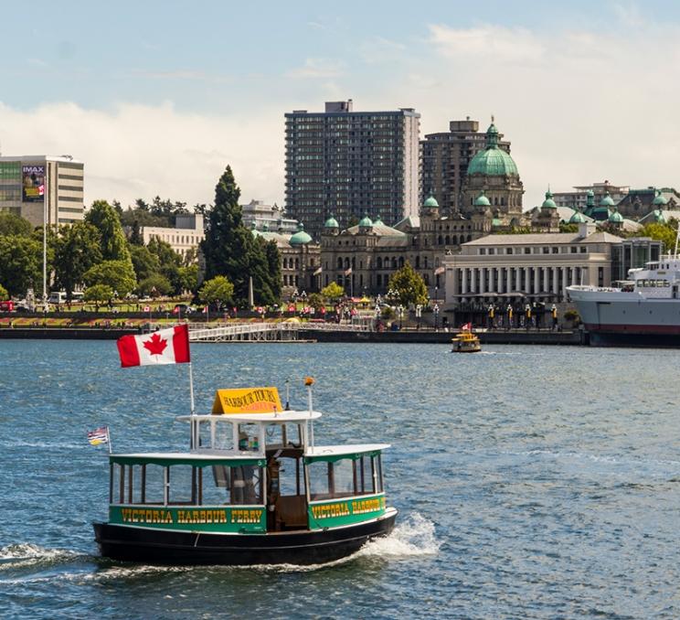 A Victoria Harbour Ferry travels across the Inner Harbour in Victoria, BC