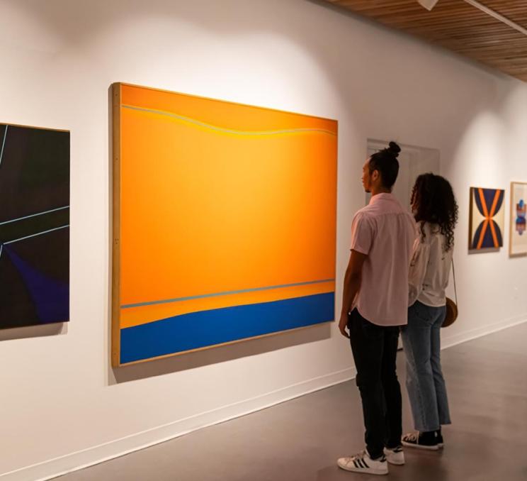 A couple looks at art exhibit in the Art Gallery of Greater Victoria in Victoria, BC