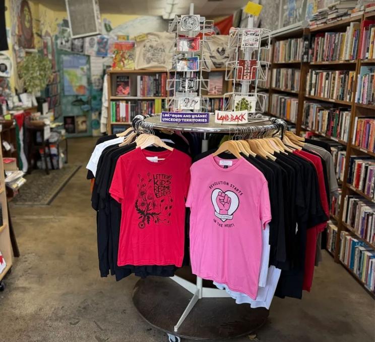 A display of t-shirts and books at Camas Books and Infoshop in Victoria, BC