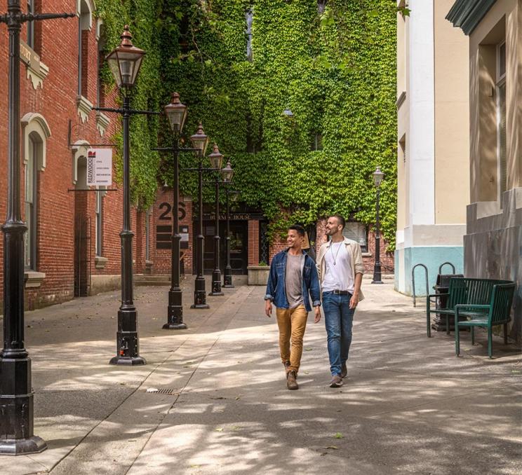 A couple walks through historic Bastion Square in Victoria, BC