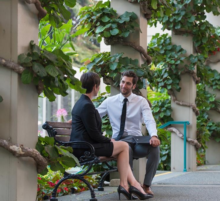 A pair of delegates have a conversation outside of the Victoria Conference Centre
