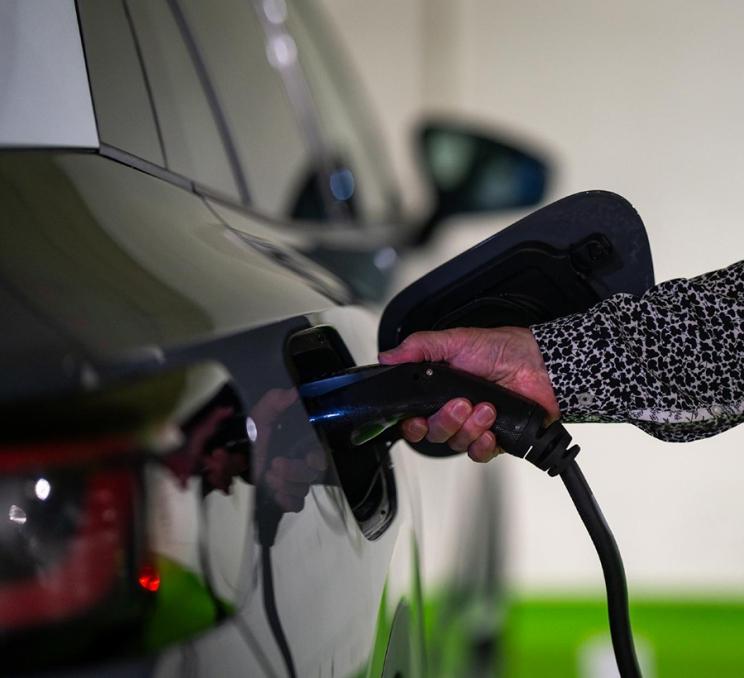 A person charges their EV vehicle at the Parkside Hotel & Spa in Victoria, BC
