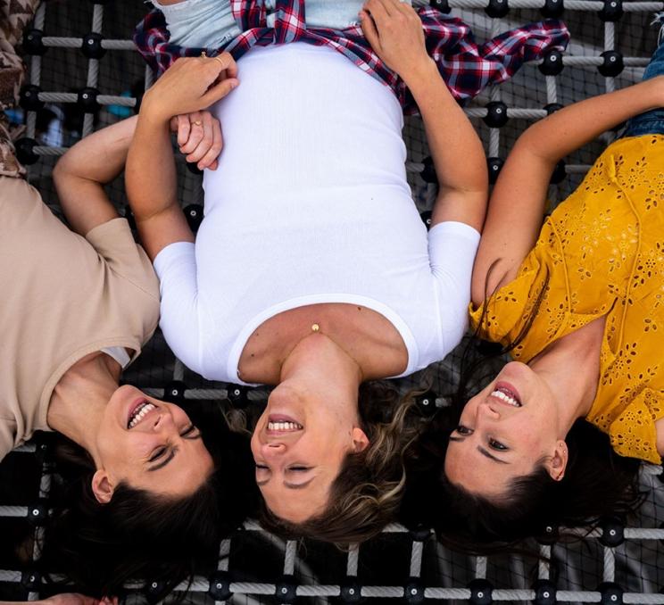 A group of friends lay atop a net at Malahat SkyWalk in Victoria, BC
