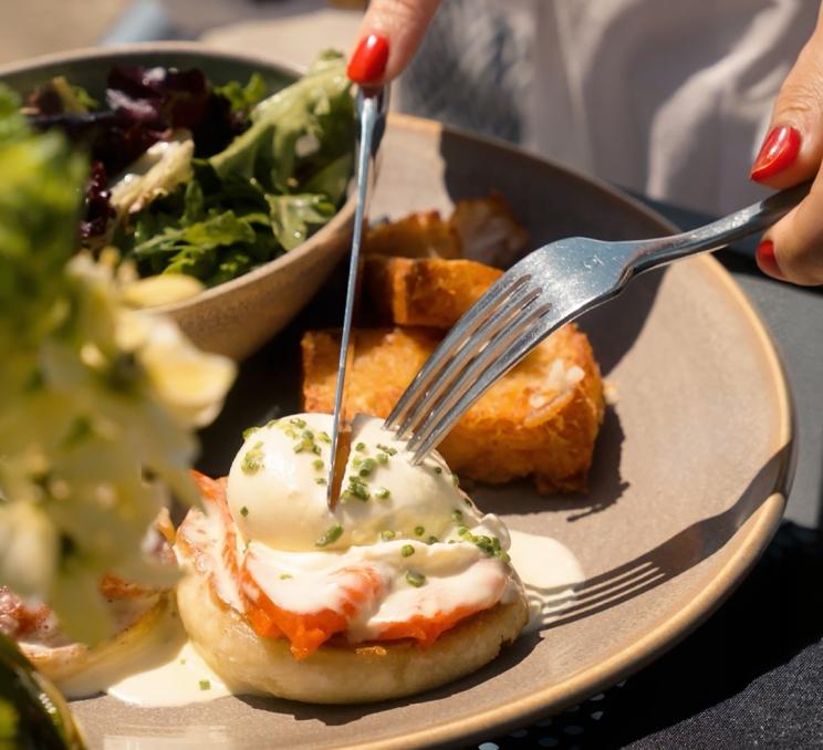 Eggs Benedict with smoked salmon, poached eggs, and hollandaise sauce at Boom + Batten in Victoria, BC