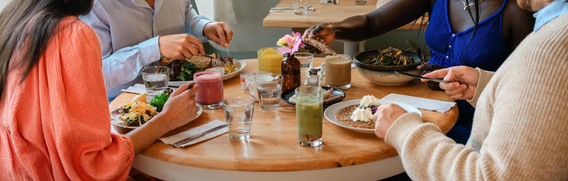 Friends sharing a healthy brunch at Nourish Kitchen & Café in Victoria, BC