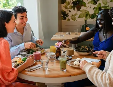 Friends sharing a healthy brunch at Nourish Kitchen & Café in Victoria, BC