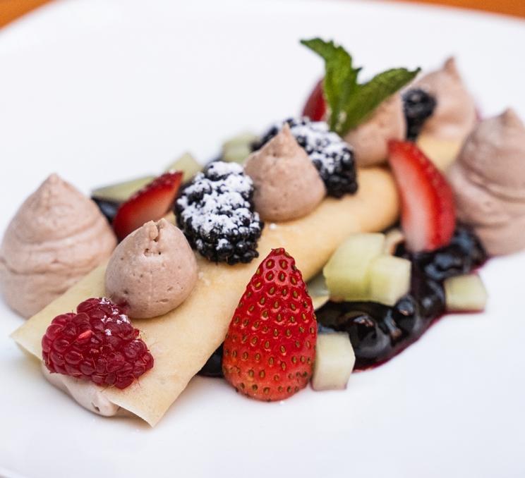 A breakfast crepe at Il Terrazzo Ristorante in Victoria, BC is adorned with fresh cream and berries