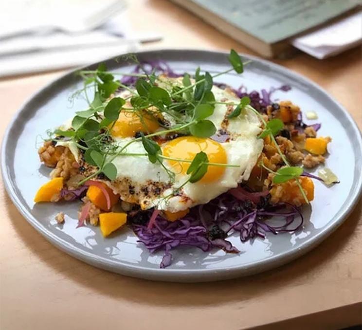 Colourful brunch hash topped with sunny-side eggs at Nourish Kitchen & Café in Victoria, BC