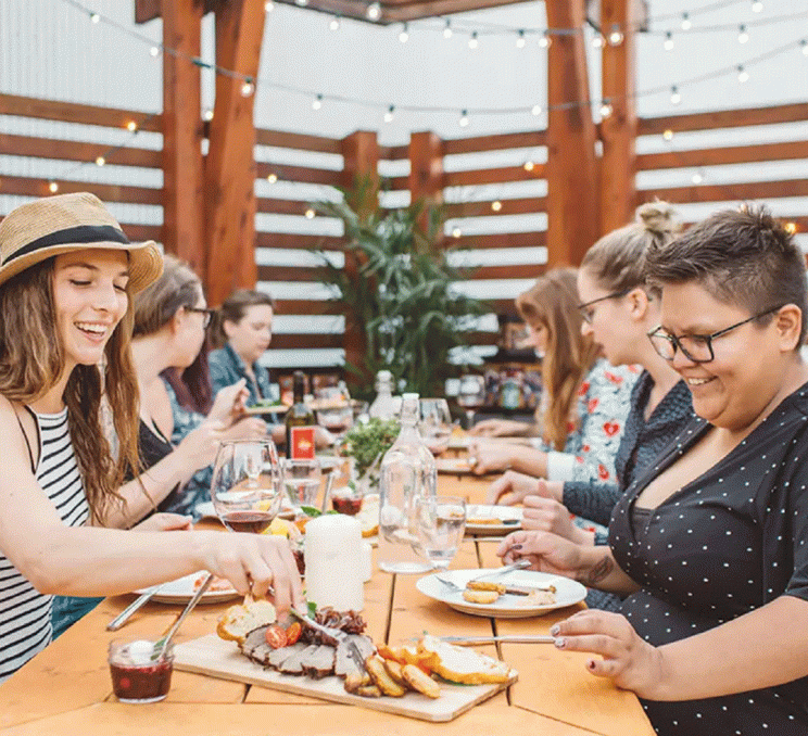 A group dines at on food provided by Songhees Events & Catering