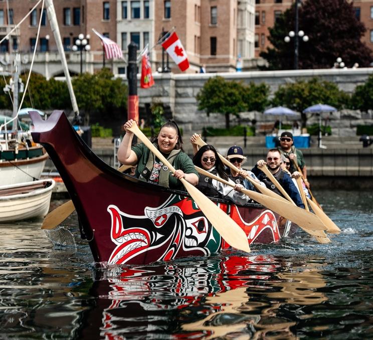 A canoe tour with Songhees Tours begins it's paddle out onto Victoria's Inner Harbour, in Victoria, BC