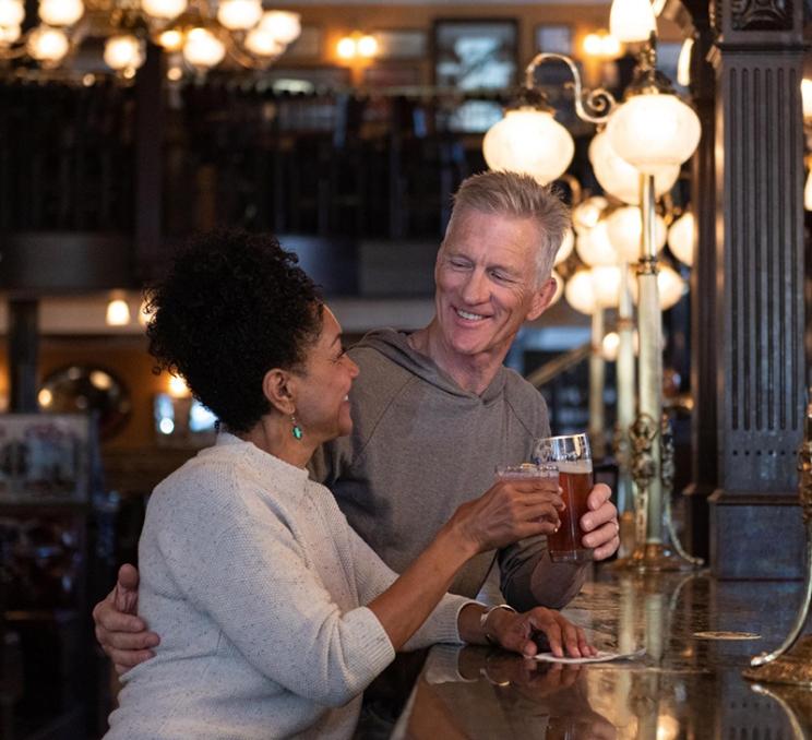 A couple enjoys drinks at the Bard & Banker in Victoria, BC