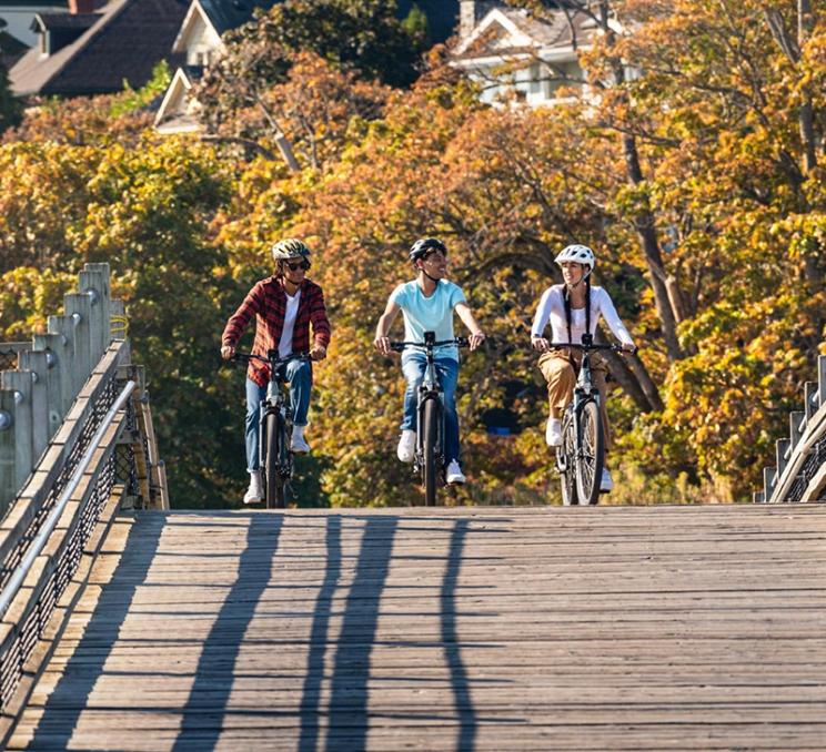 A group of cyclists rides along the Selkirk Trestle in Victoria, BC