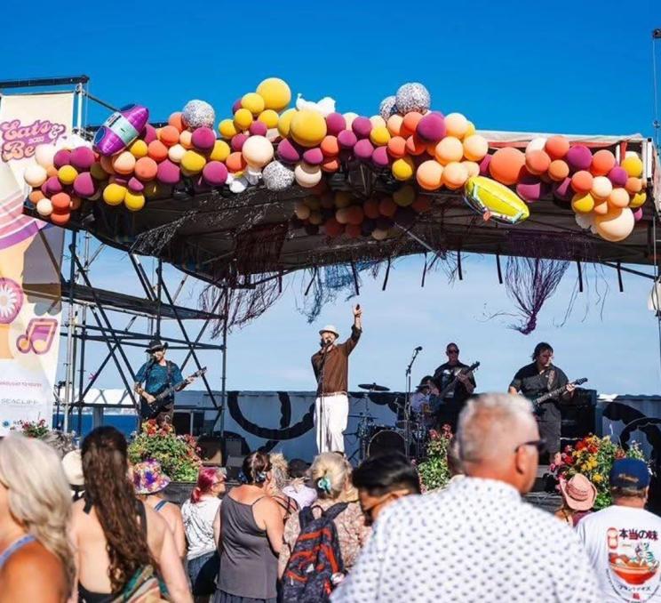 A band performs onstage at Beachlands Eats & Beats Beach Party in Victoria, BC