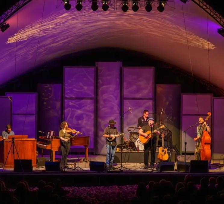 A group of performers on stage during The Butchart Gardens Outdoor Summer Concert Series in Victoria, BC