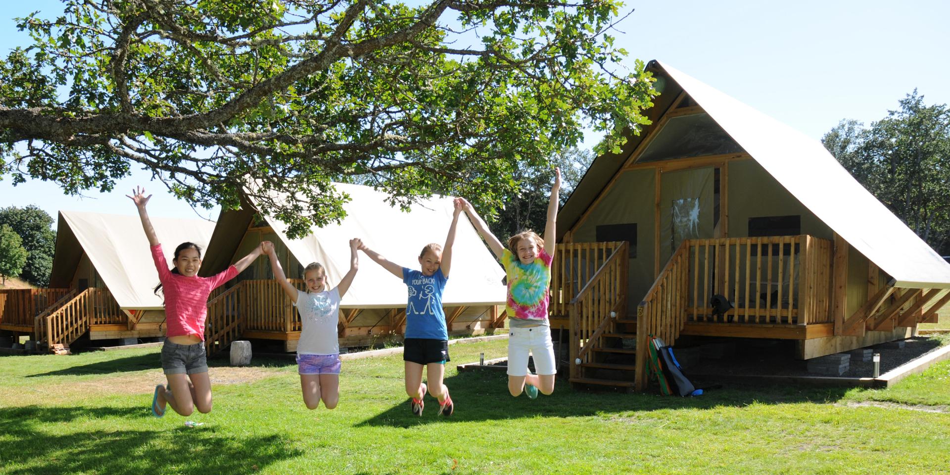 Four young girls are enjoying an overnight stay with their families.