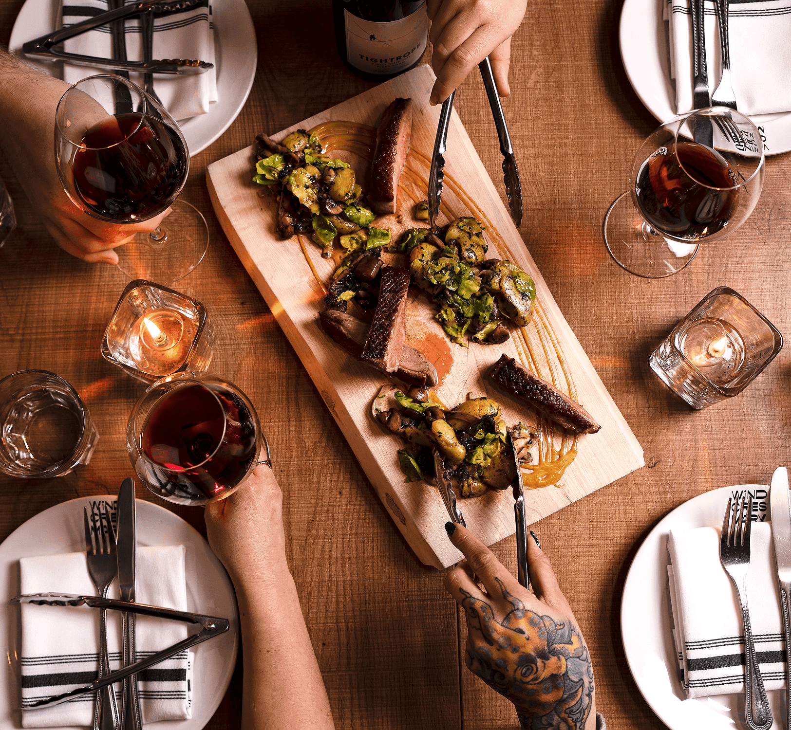 An aerial view of people sharing a steak dinner in Victoria, BC