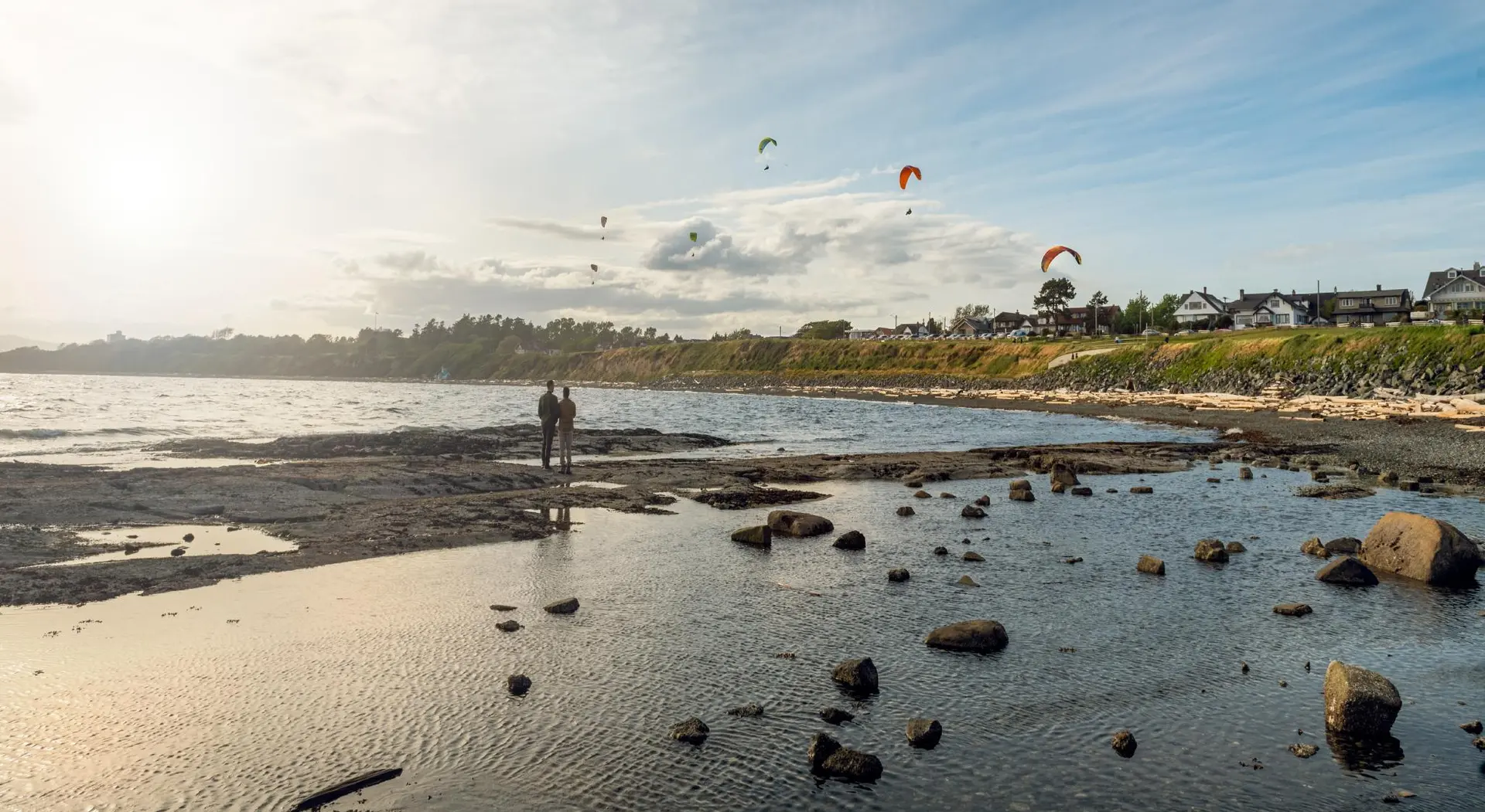 A couple explores Dallas Road Beach