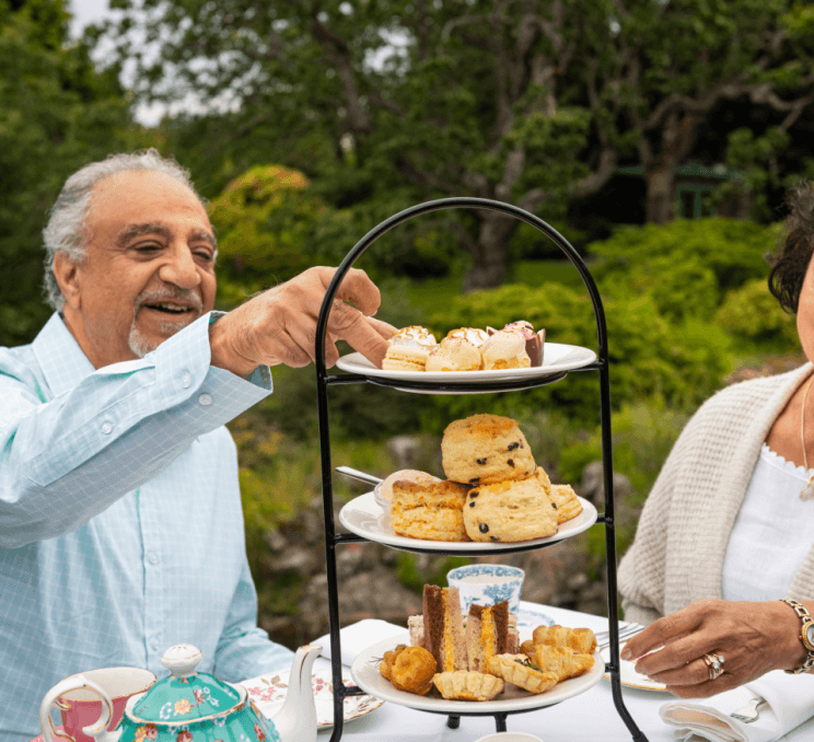 A couple enjoying tea in Abkhazi Garden in Victoria, BC