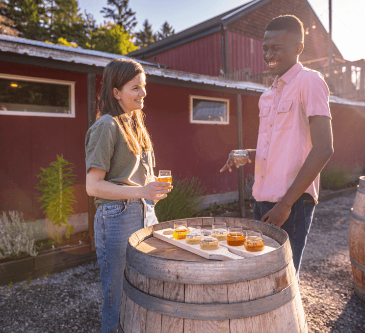 A couple enjoying a cider at a cidery in Victoria, BC