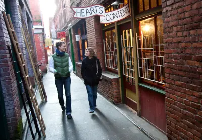 A couple walking through Fan Tan Alley in Victoria, BC