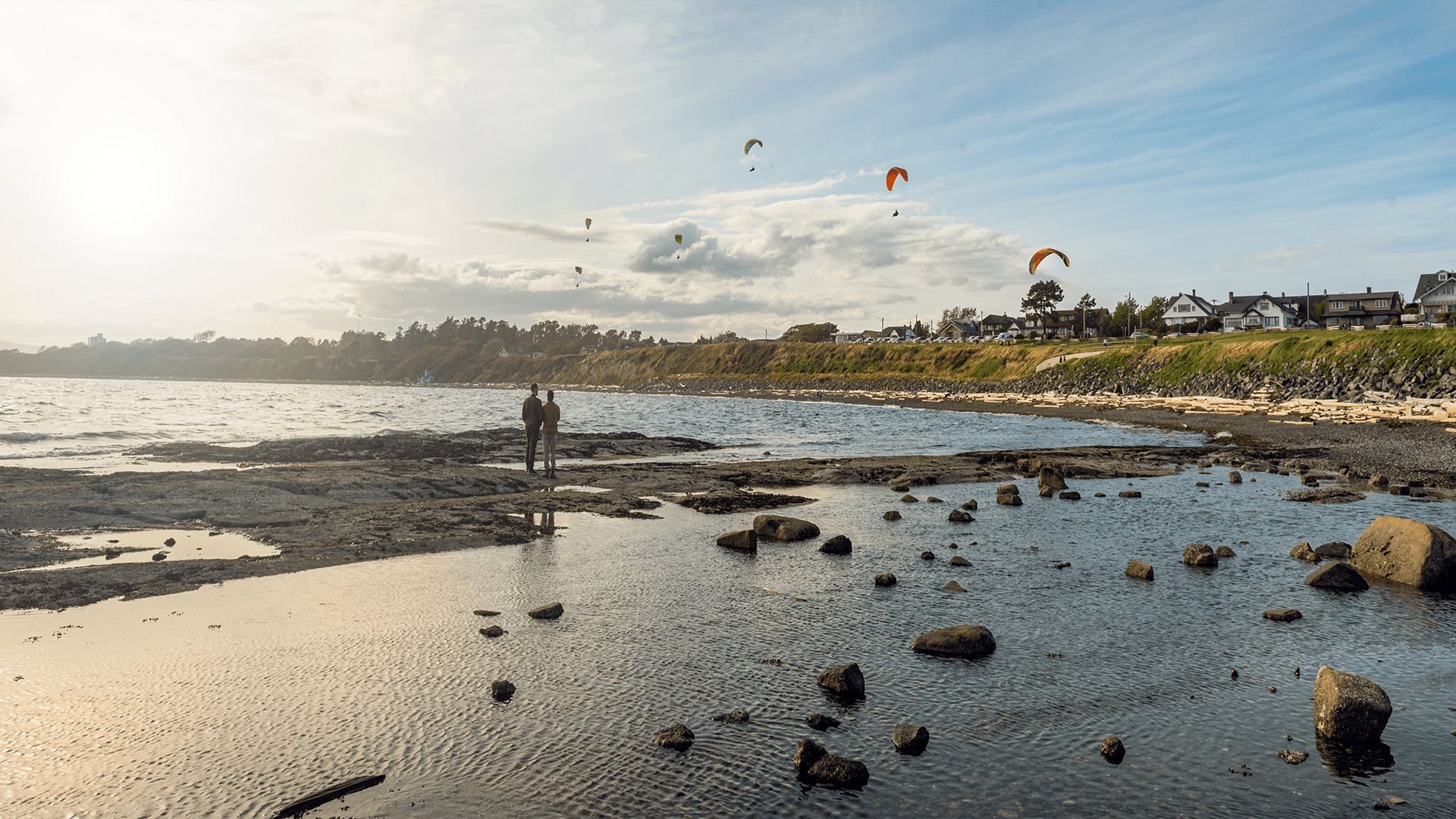 A couple watching kites at Cattle Beach in Victoria, BC