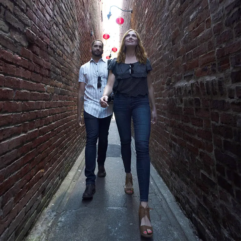 A Couple Casually Walks Through Fan Tan Alley, Canada's Narrowest Alley