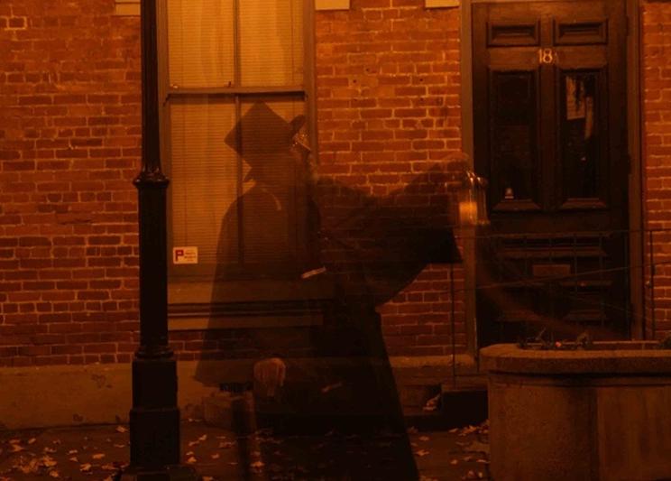A shadow of a person wearing a top hat at the Ghostly Walks Tour