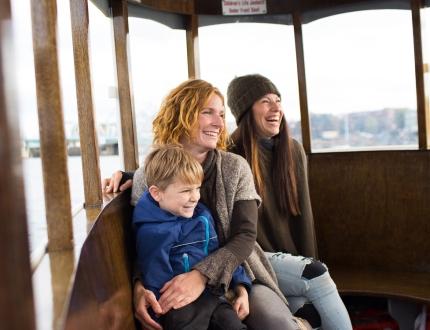 a happy family aboard a ferry in Victoria's inner harbour
