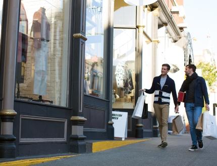 male couple walking downtown, shopping