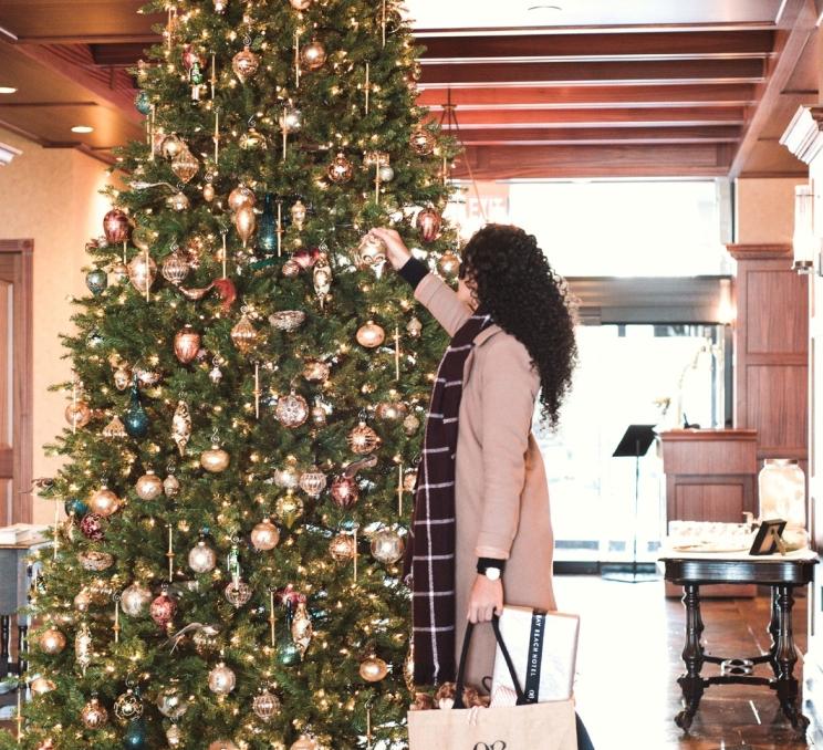 A person decorating a tree at Oak Bay Beach Hotel in Victoria, BC