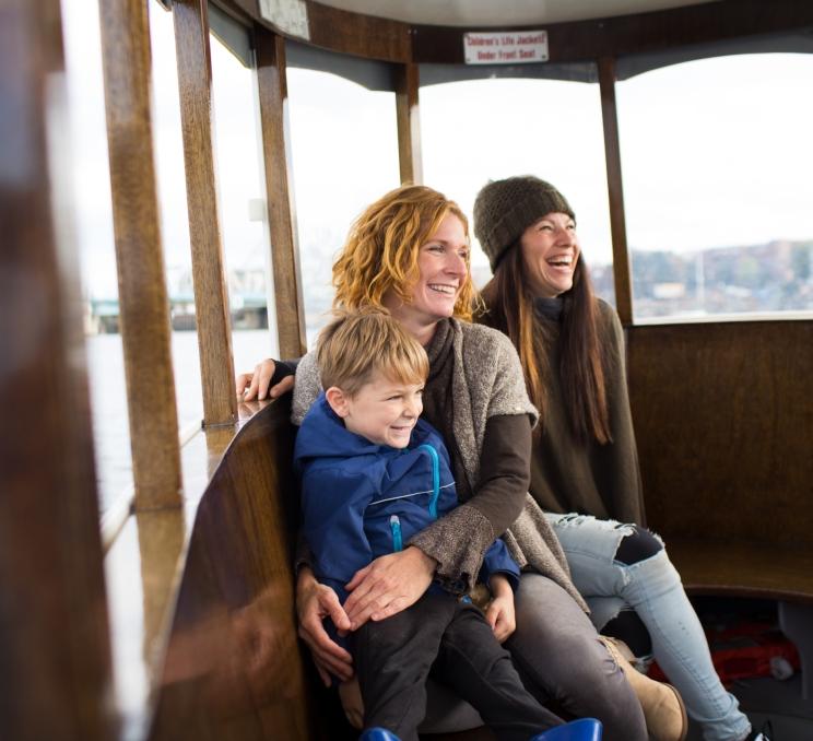A family enjoying a Harbour Ferry ride around the inner harbour in Victoria, BC