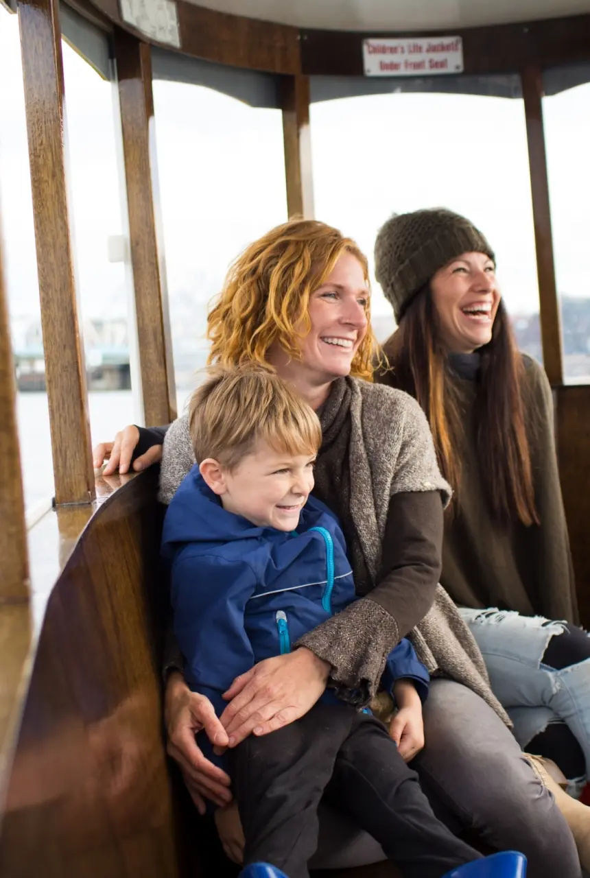 A family enjoying a Harbour Ferry ride around the inner harbour in Victoria, BC
