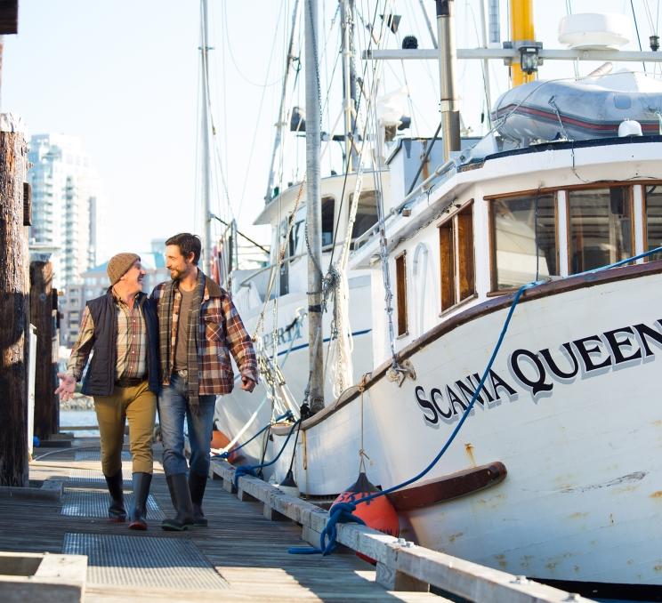 A couple walks the docks in Victoria, BC