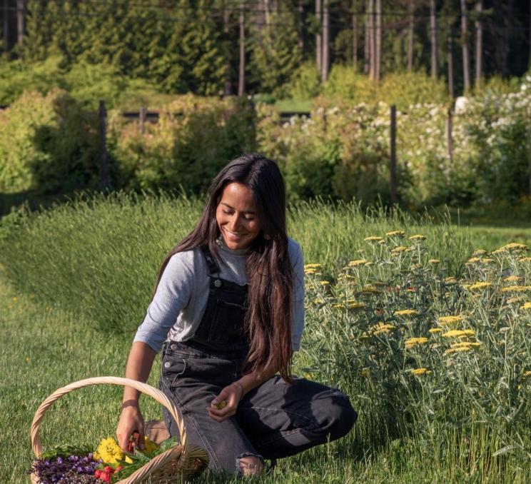 A woman gathering produce at a farm in Victoria, BC