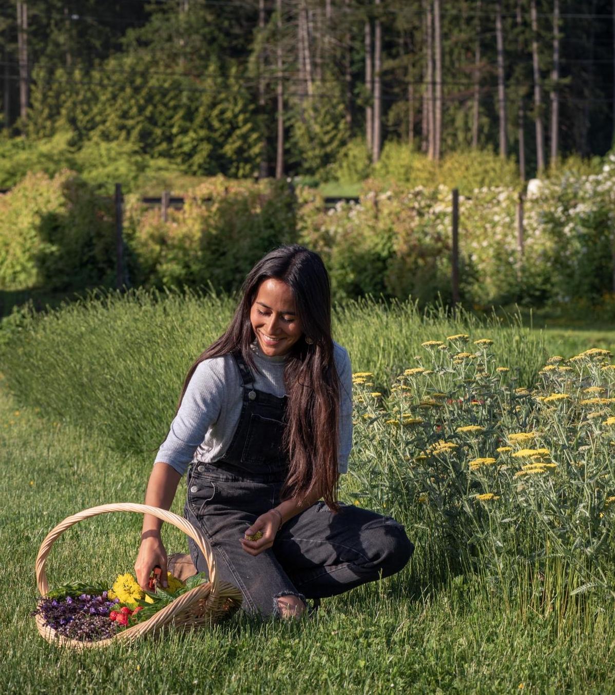 A woman gathering produce at a farm in Victoria, BC
