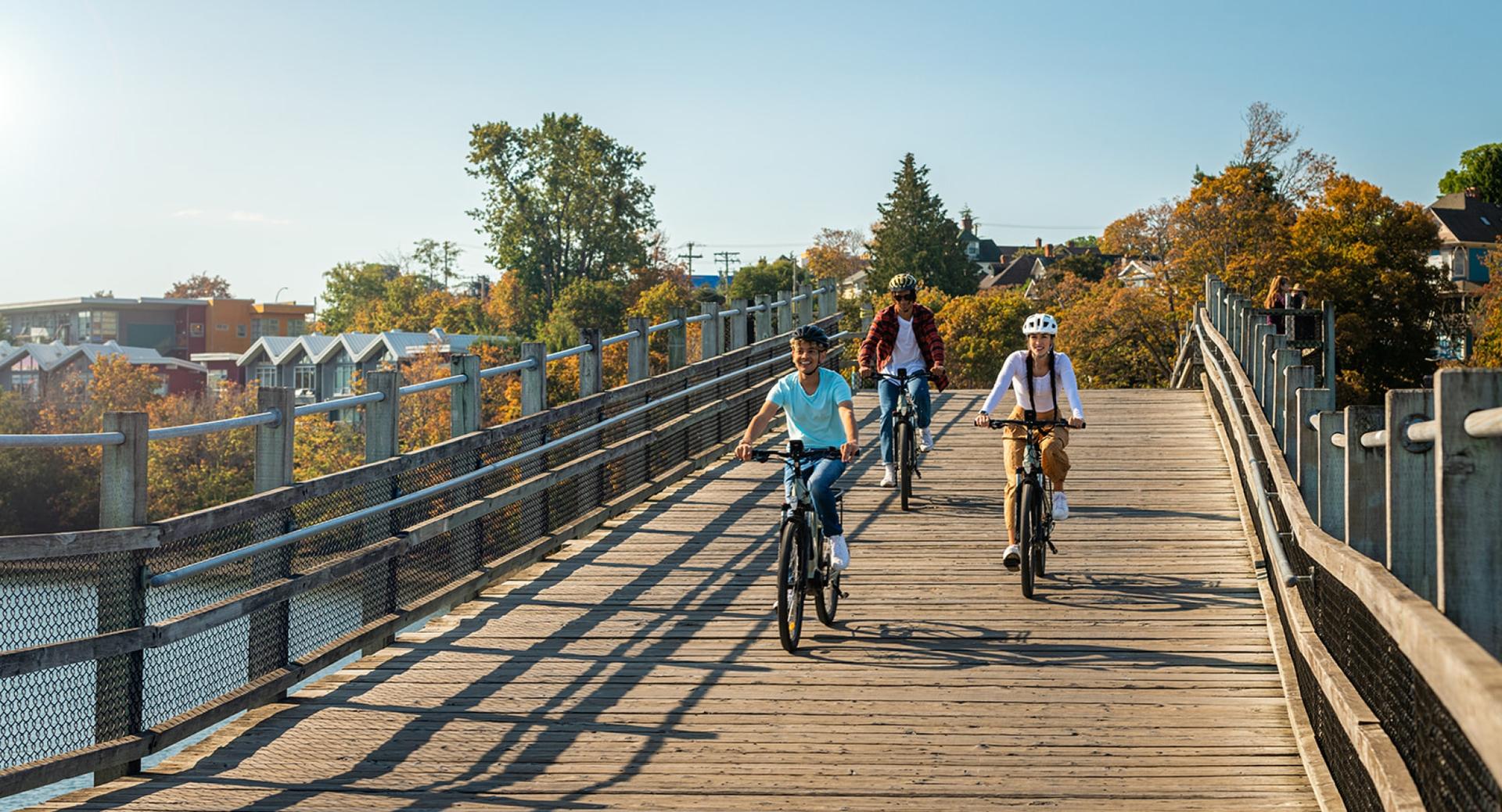A group of friends cycling along the Selkirk Trestle in Victoria, BC