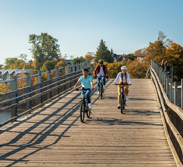 A group of friends cycling along the Selkirk Trestle in Victoria, BC