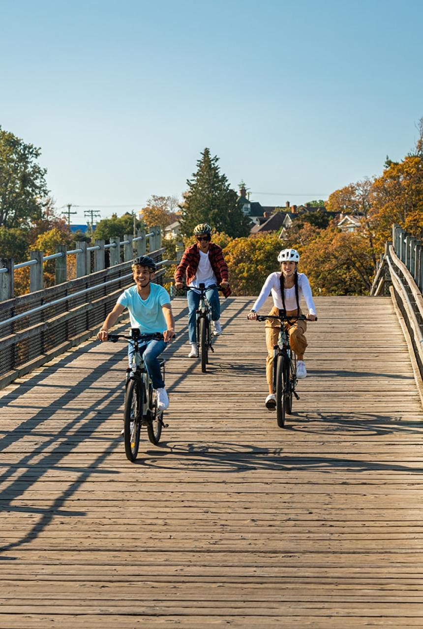 A group of friends cycling along the Selkirk Trestle in Victoria, BC
