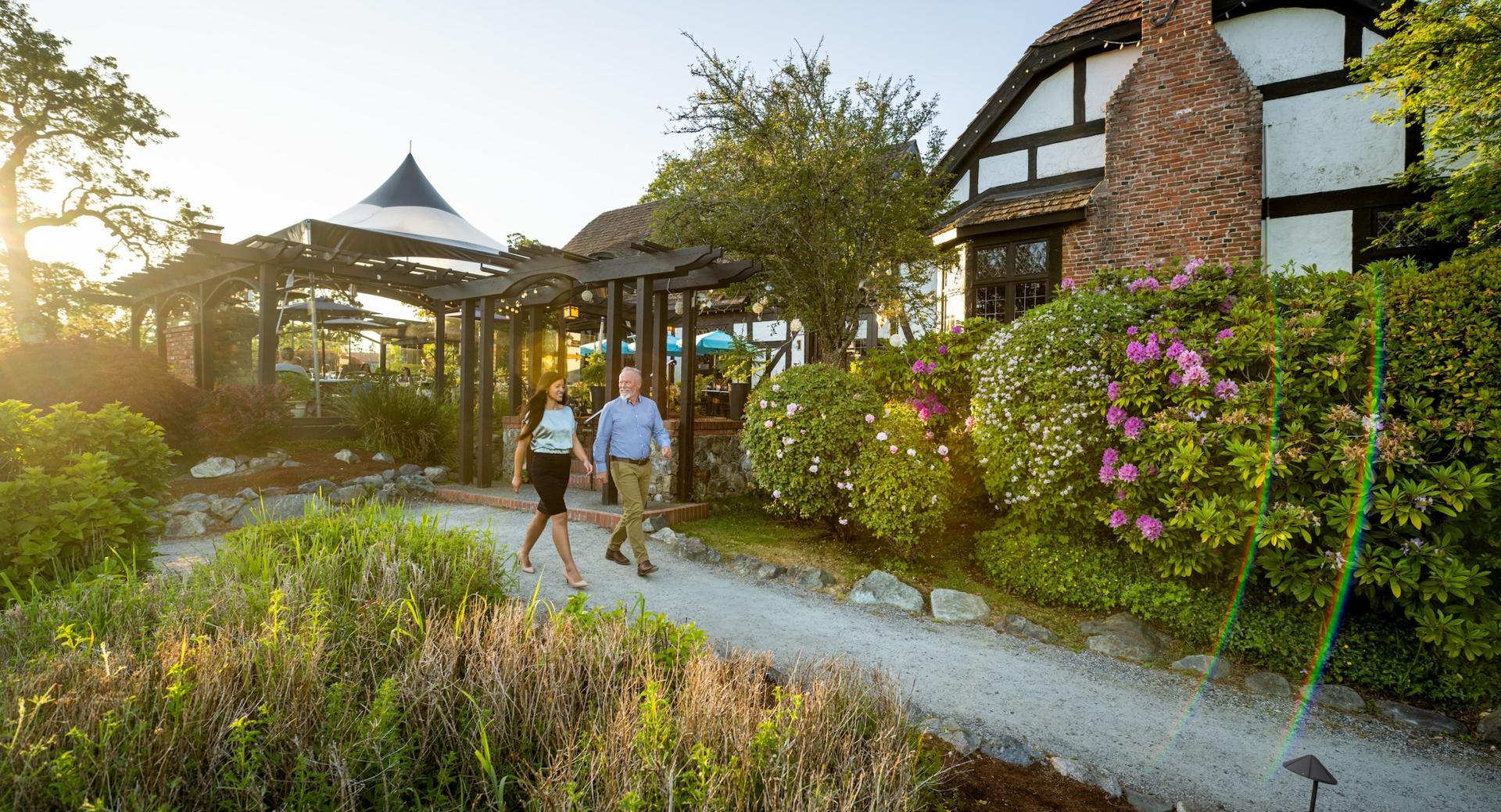 A couple walking outside a restaurant in Victoria, BC