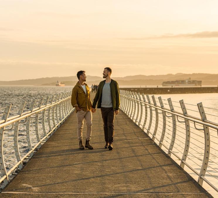 A couple explores Dallas Road in Victoria, BC