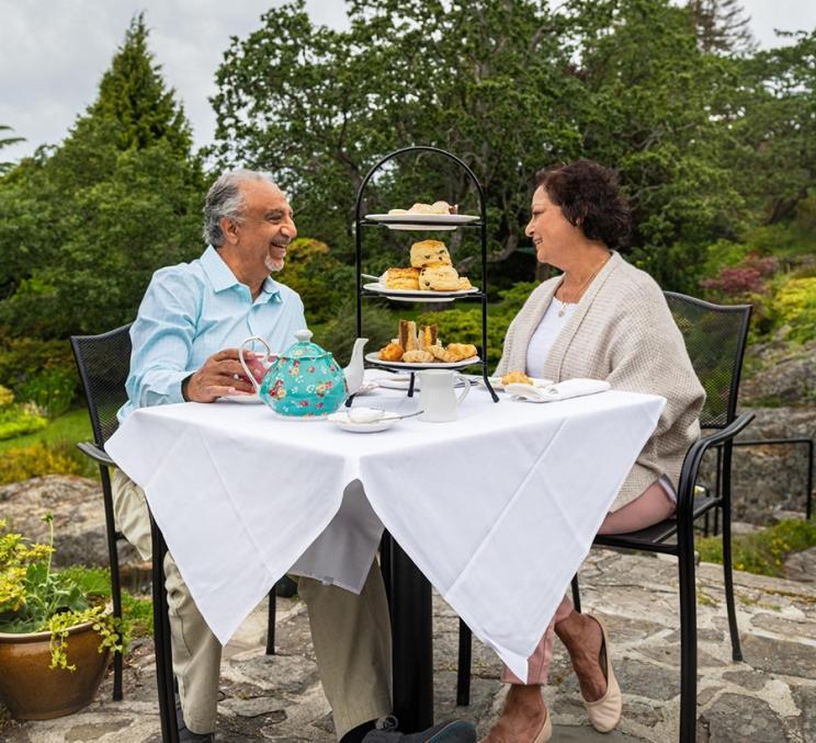 A couple enjoys afternoon tea at Abkhazi Garden in Victoria, BC