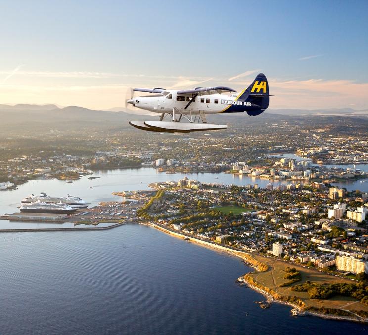 A Harbour Air Seaplanes flight flies along the coastline of Victoria, BC during a scenic tour.