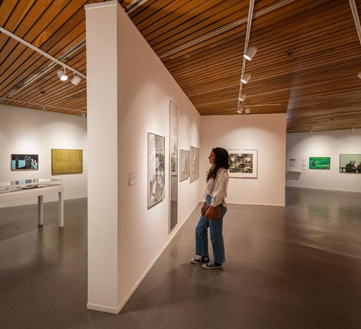A woman examines some artwork at the Art Gallery of Greater Victoria in Victoria, BC