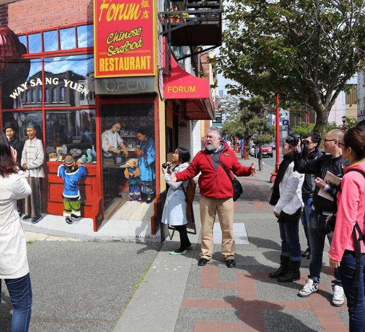 A guide tells a story during a Discover the Past Walking Tour in Victoria, BC